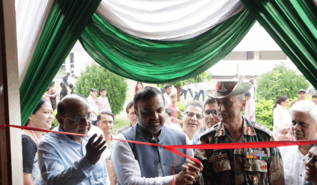 Dr. Ketan Mohitkar, Yogeshbhai Patel, and Col. Vikas C. Sharma cutting the ribbon and inaugurating the Arts Exhibition